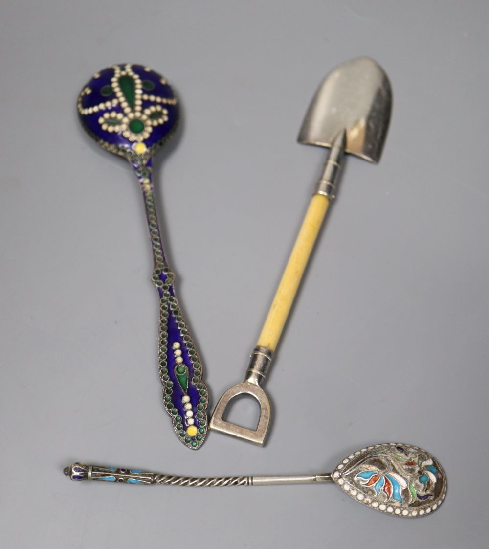 An early 20th century Russian 84 zolotnik and cloisonne enamel spoon, 13.2cm, a white metal and enamel spoon and a plated shovel